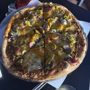 Coney Dog Pizza. Coney sauce, hot dog slices, jalapeño, cheddar, onion.