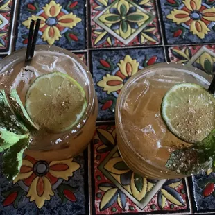 two cocktails with lime and mint