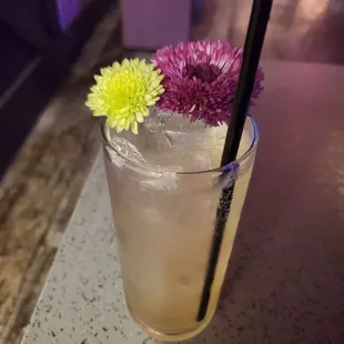 a glass of lemonade with a straw