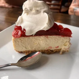 a slice of cheesecake with whipped cream on top