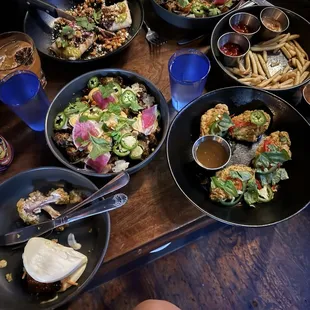 Crispy Brussels Sprouts, pork belly bao buns, salt and pepper wings, fries, tamale