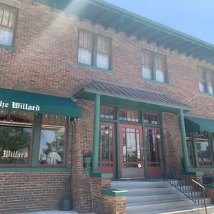 a brick building with a green awning