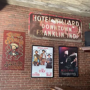 a brick wall with posters on it