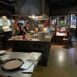 a restaurant kitchen with people preparing food