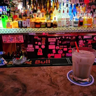 a drink in a tall glass on a bar