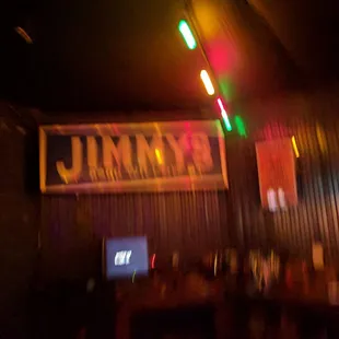 a bar with a neon sign above it