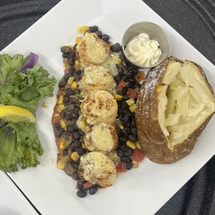 Scallops over black bean and corn salad