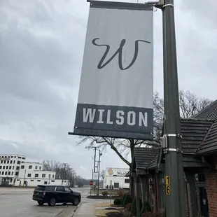banner located along sidewalk between cafe and pharmacy
