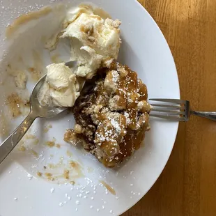 partially consumed apple torte with vanilla ice cream