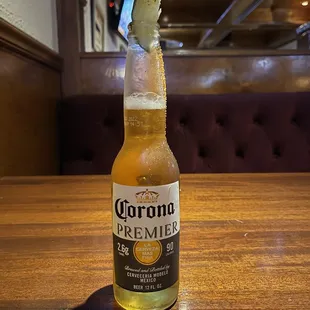 a bottle of corona beer on a table