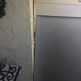 Fence separated from the wall, entire enclosure is leaning.