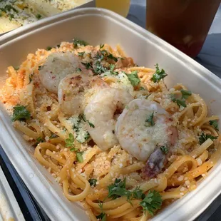 a tray of pasta with shrimp and parmesan