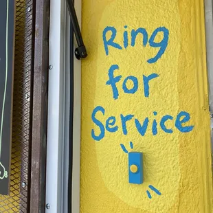 a sign that says ring for service