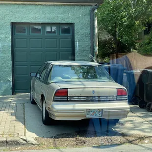 a car parked in front of a garage