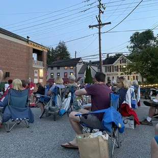 a group of people sitting in lawn chairs