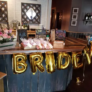 a bridaly sign and balloons
