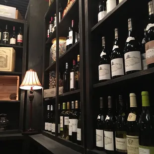 a shelf full of wine bottles