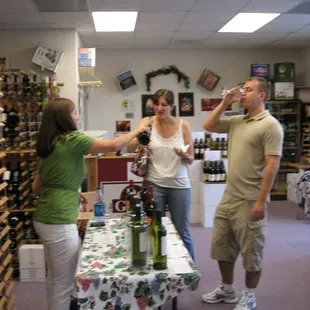 a woman pouring wine into a glass