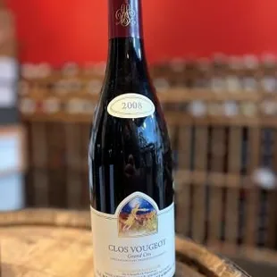 a bottle of red wine on a barrel