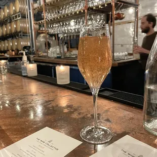 a glass of wine on a bar