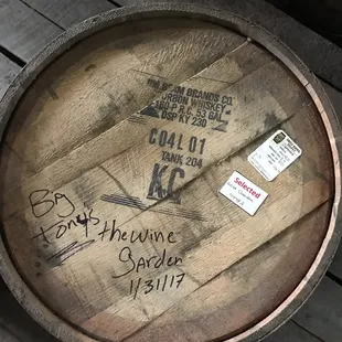 a wooden barrel with writing on it