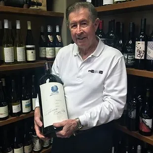 a man holding a bottle of wine