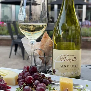 a plate of cheese and grapes