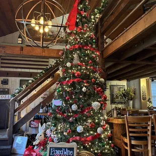 a decorated christmas tree and a sign