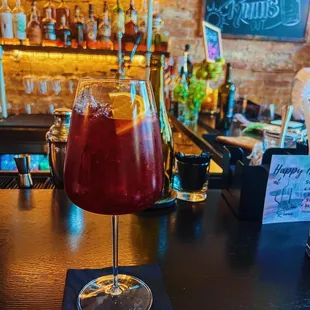 a glass of wine on a bar