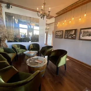 a wine tasting room with green chairs