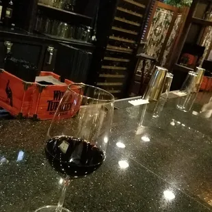 a glass of wine on the bar