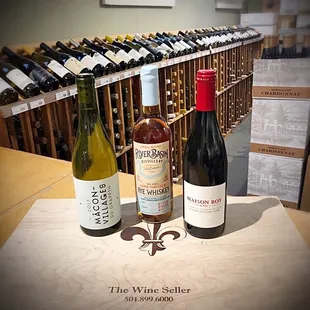 three bottles of wine on a table