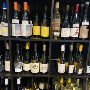 a shelf full of wine bottles