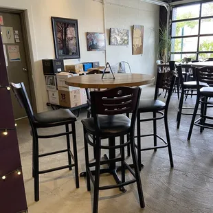 a table with chairs and a refrigerator