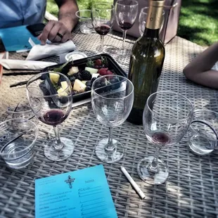 a table with wine glasses and a menu