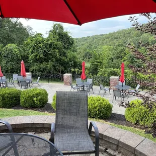 a patio with chairs and umbrellas