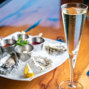 a plate of oysters and a glass of champagne