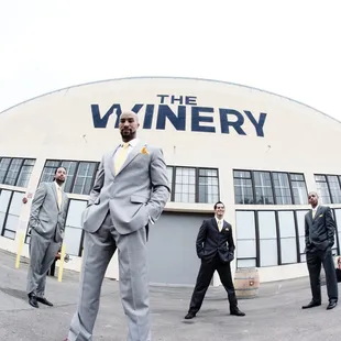 Groomsmen taking a photo in front of the winery