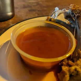 a plate of food with dipping sauce