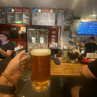 a person holding a glass of beer