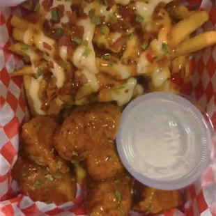 a basket of chicken wings and fries