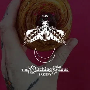 a hand holding a pastry
