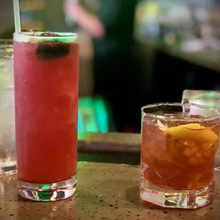 two cocktails on a bar