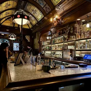 a bar with a lot of bottles on the counter