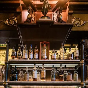 a shelf full of liquor bottles