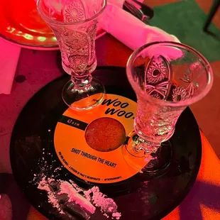 two empty glasses on a black plate