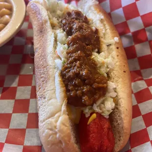 Hot dog with chili, mustard, and slaw