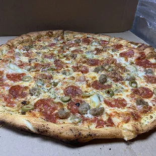 Pepperoni, green olive, and sausage pizza