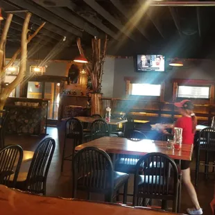 a woman walking through the dining area