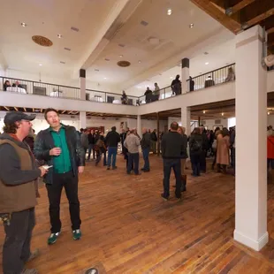 a crowd of people standing in a hall